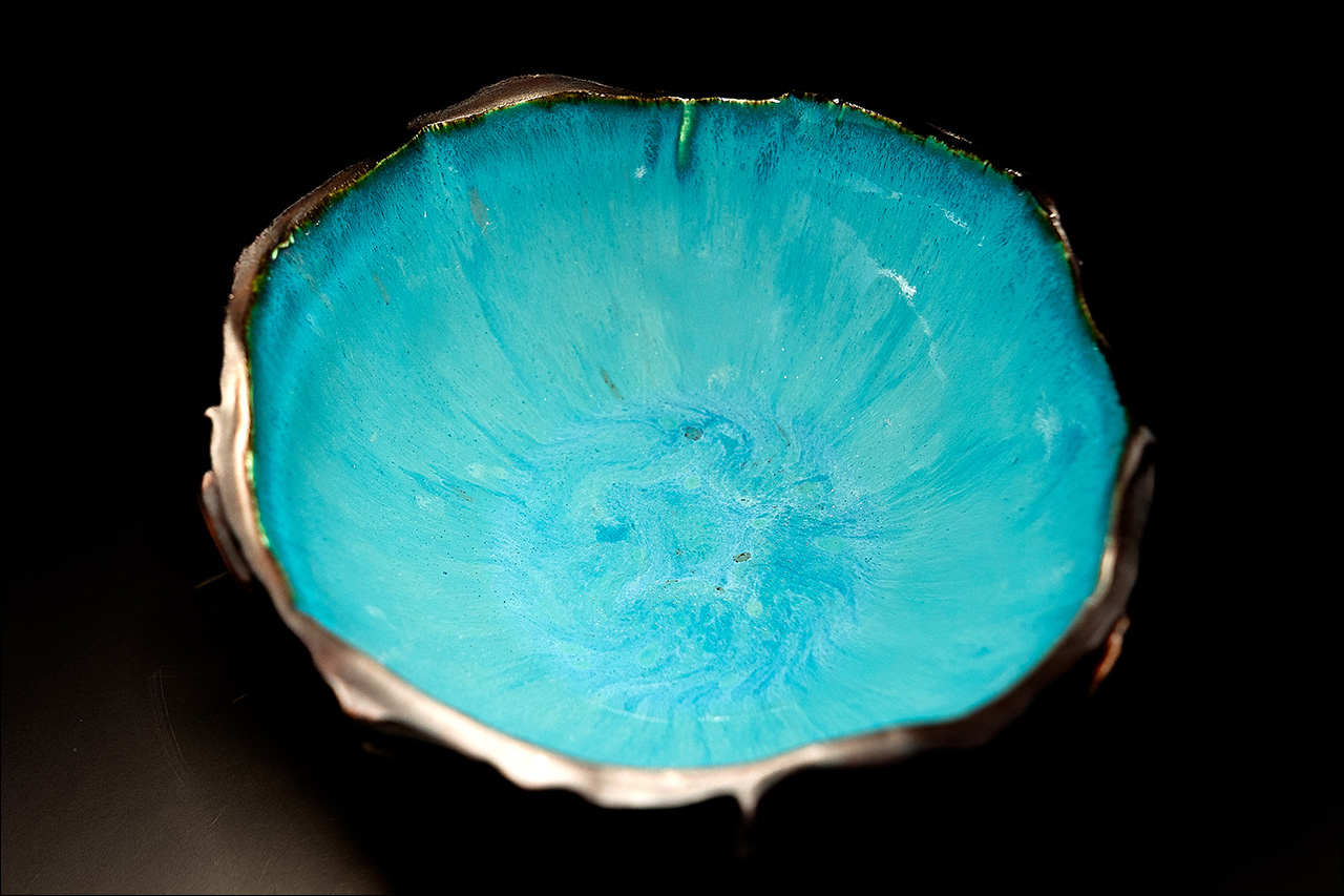 Image of a nature-inspired handmade porcelain bowl with a vibrant turquoise glaze. Made by Leona Darnell