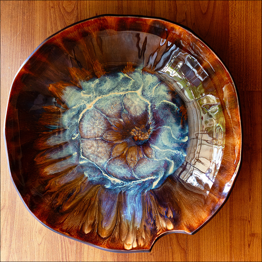 Image of a handmade large porcelain bowl. Made with vibrant glaze by Leona Darnell.